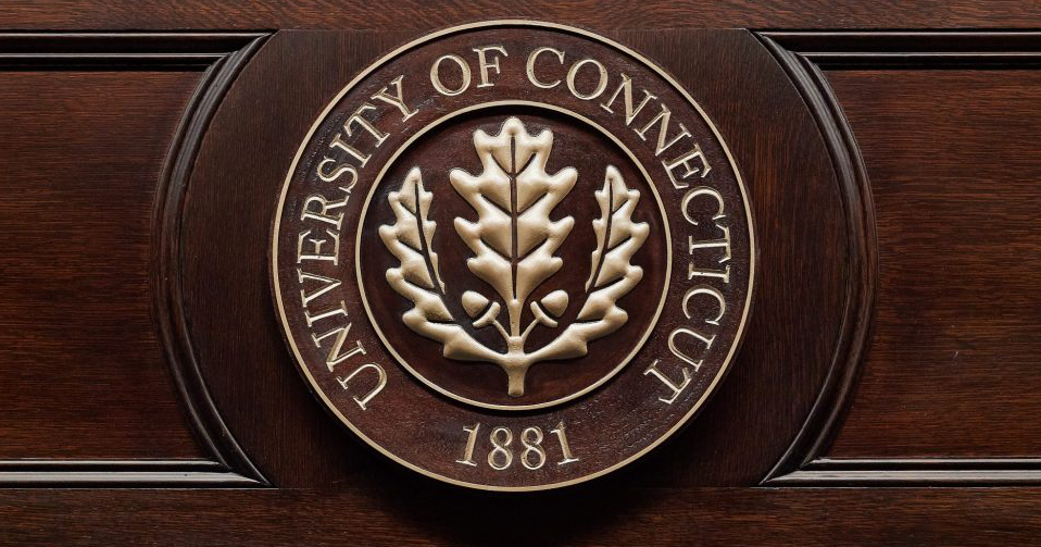 uconn seal on wood background