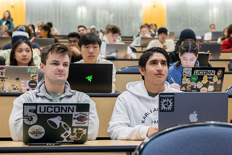 students in class with laptops