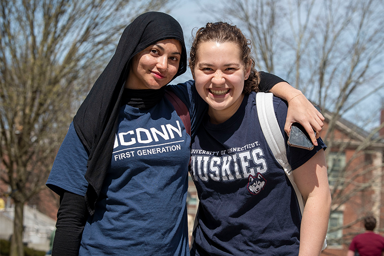 students with uconn shirts pose for photo